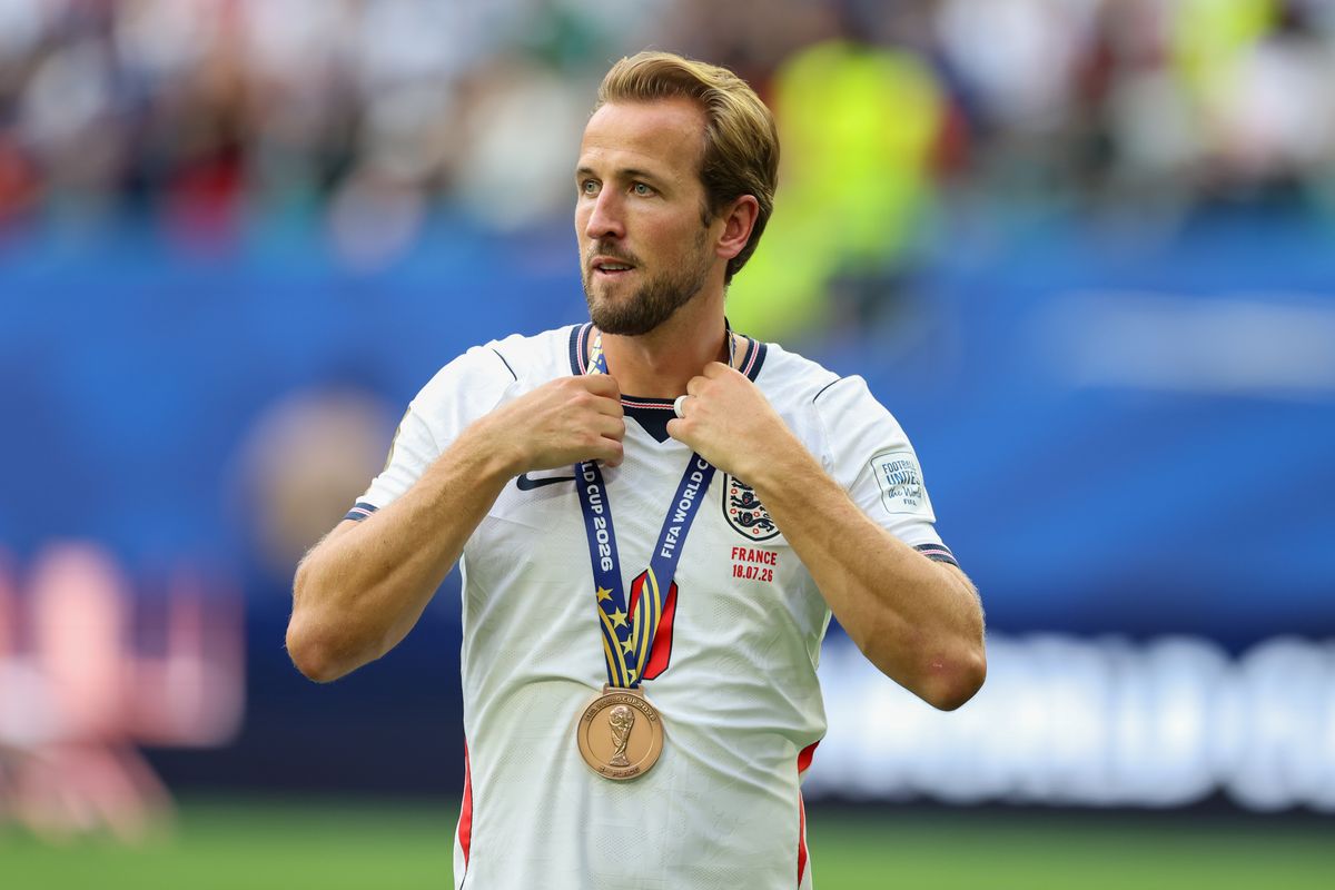 Harry Kane wears his medal