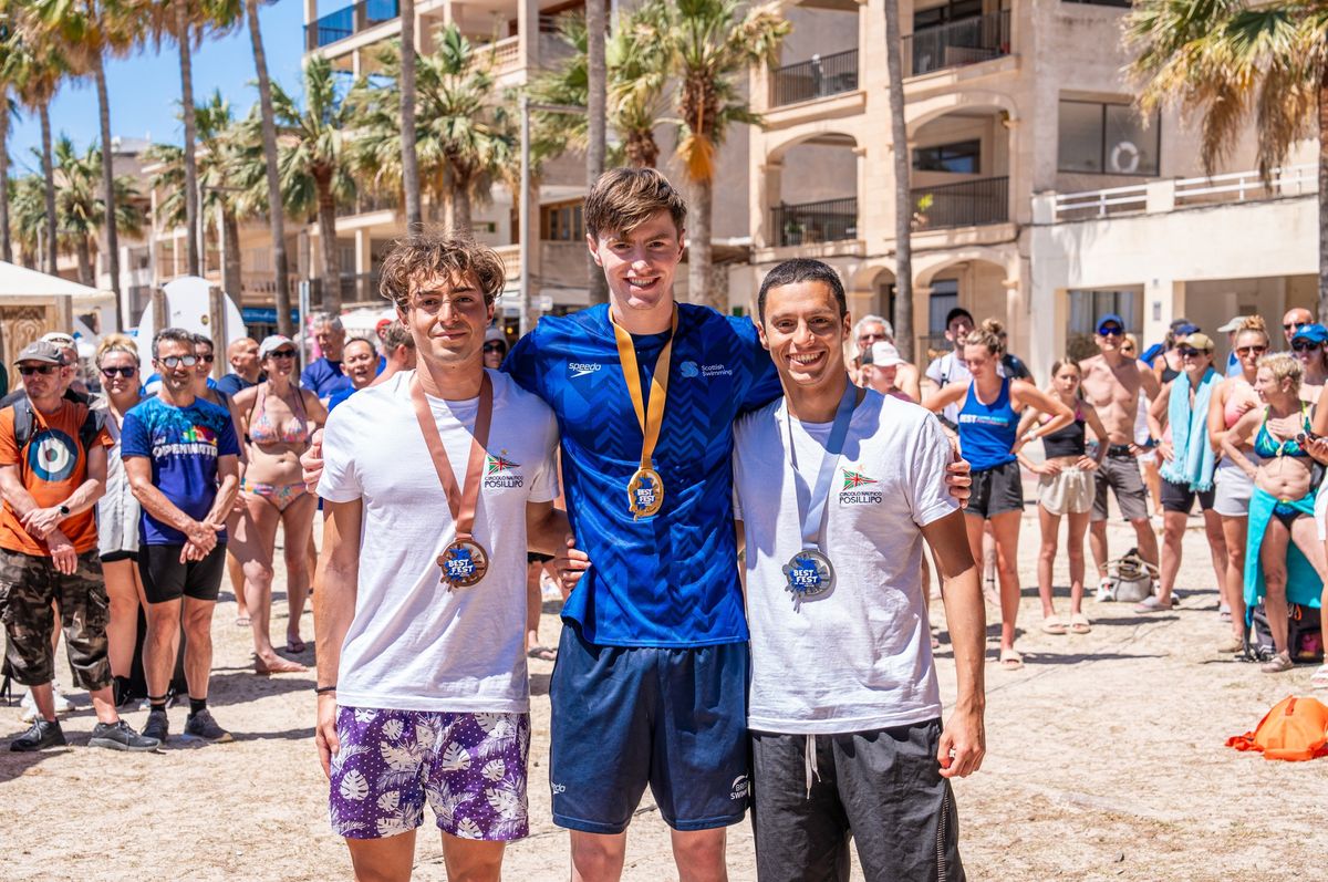 Sean McCann on a beach with fellow competitors following a youth games event