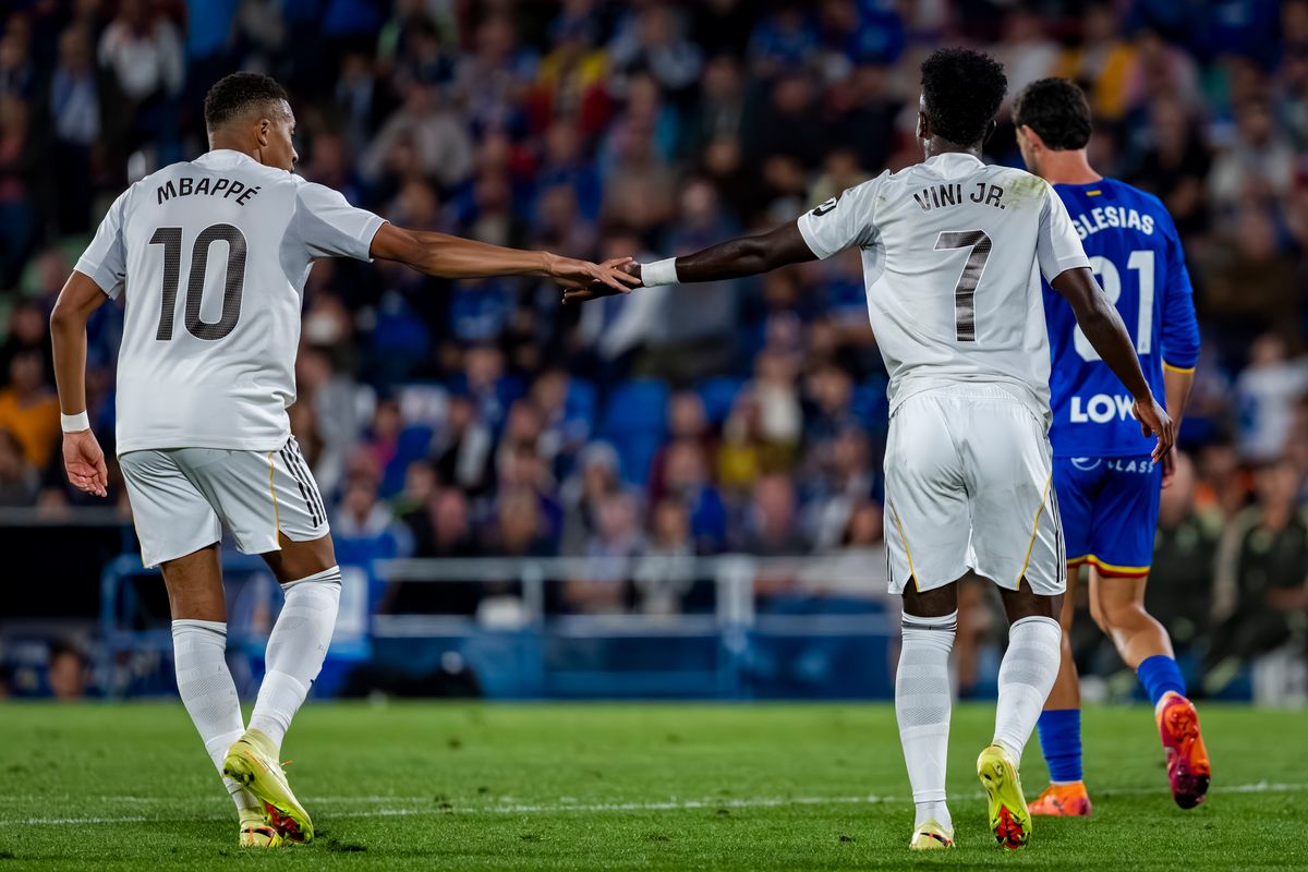 Kylian Mbappe of Real Madrid shakes hands with Vinicius Junior of Real Madrid during the LaLiga EA Sports football match between Getafe CF and Real Madrid CF at Coliseum Alfonso Perez
