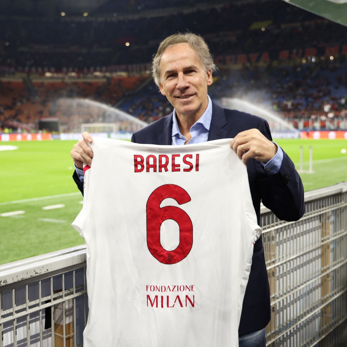 Franco Baresi holds a shirt up