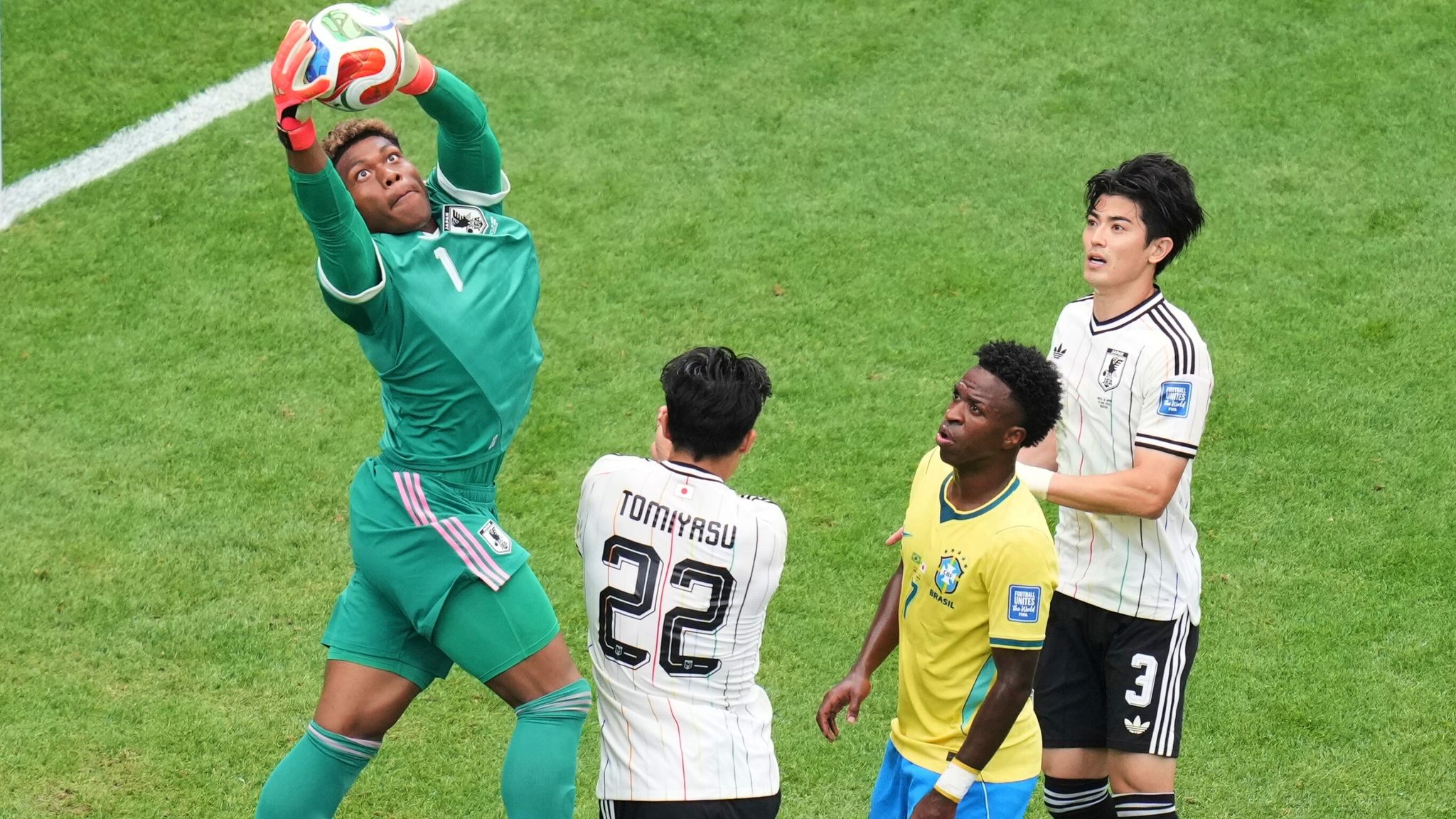 Japan goalkeeper Suzuki catches the ball during the World Cup game against Brazil