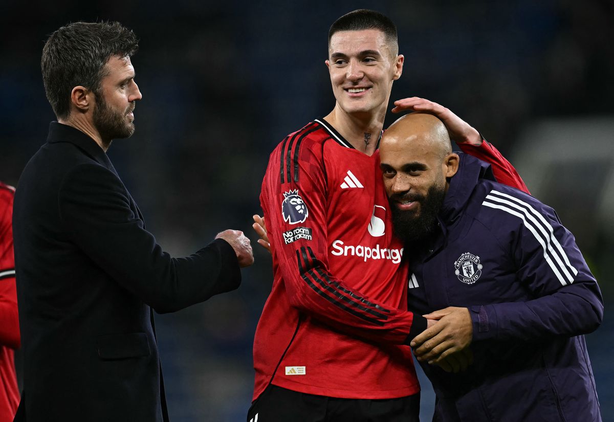Manchester United's English Interim head coach Michael Carrick (L) reacts as Manchester United's Slovenian striker #30 Benjamin Sesko (C) celebrates with Manchester United's Cameroonian midfielder #19 Bryan Mbeumo after the English Premier League football match between Everton and Manchester United at the Hill Dickinson Stadium in Liverpool, north west England on February 23, 2026.