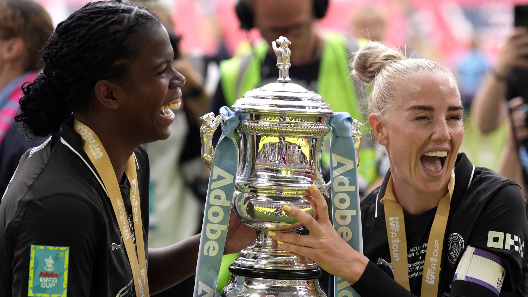 Alex Greenwood and Bunny Shaw celebrate with the FA Cup trophy
