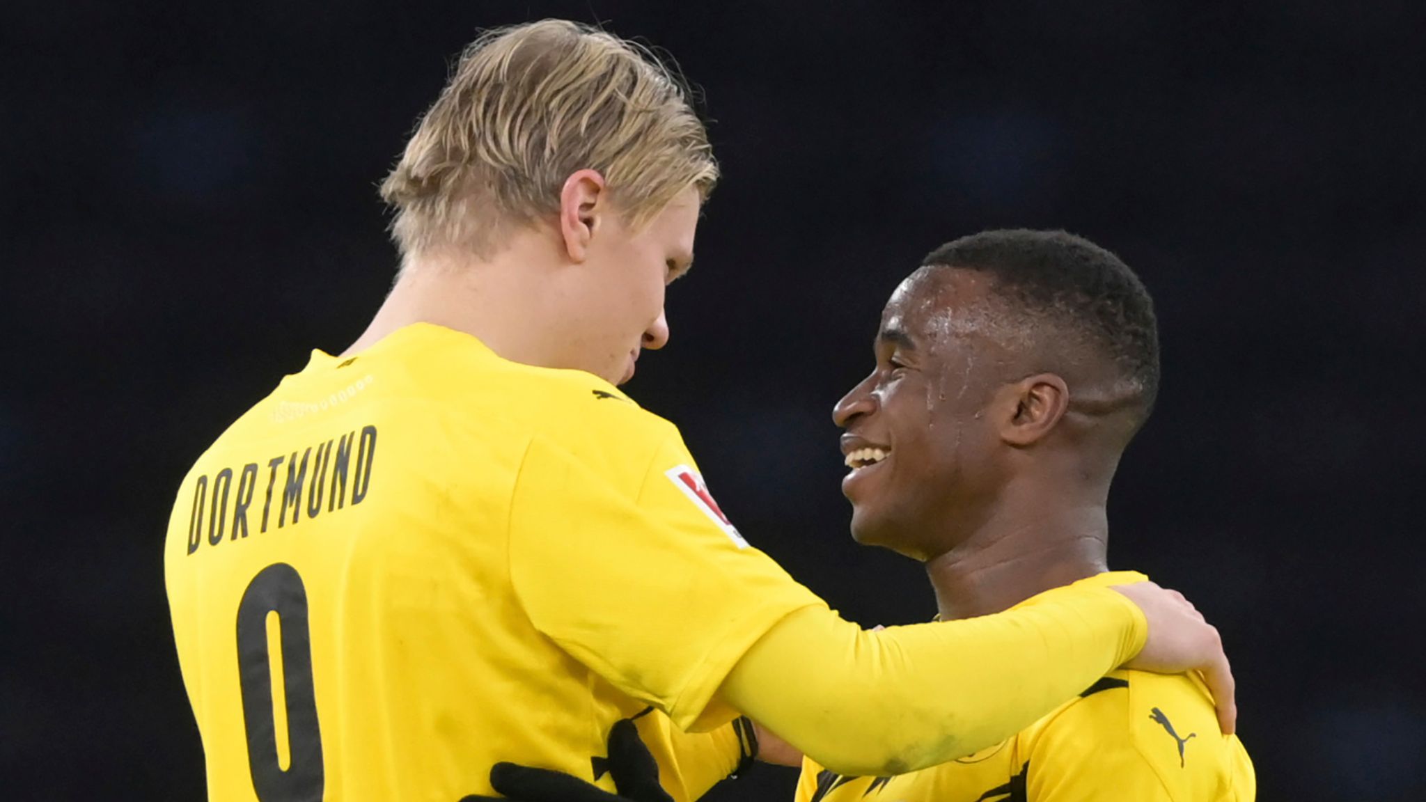Erling Haaland and Youssoufa Moukoko embrace during their time at Borussia Dortmund