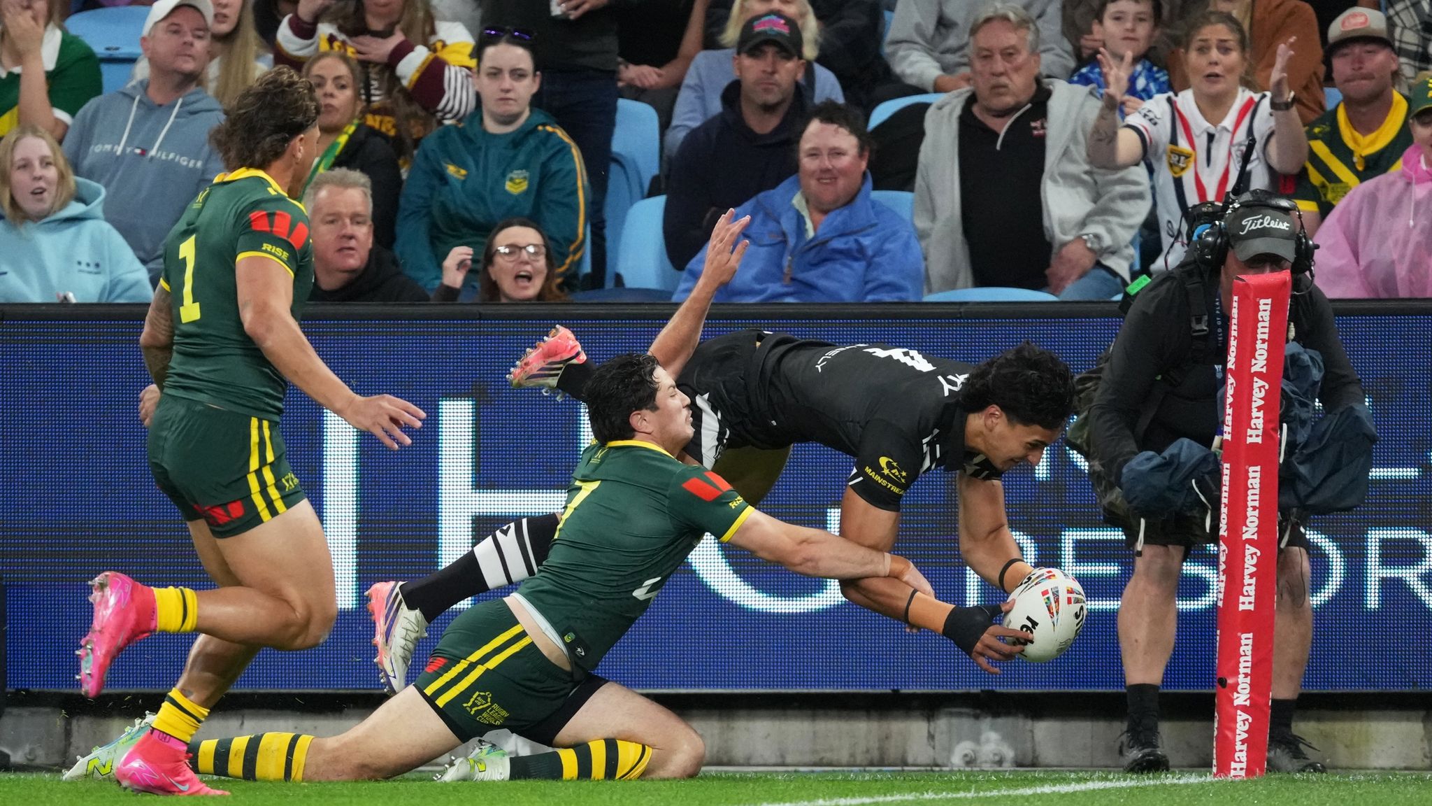 New Zealand's Casey McLean dives in the corner to score a try against Australia. (AP Photo/Mark Baker)