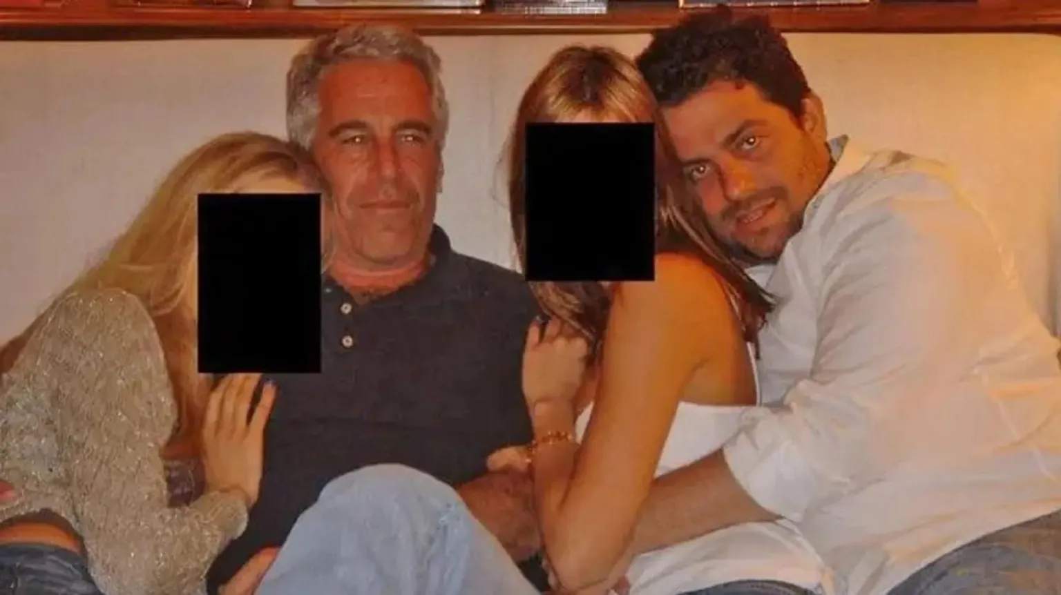 US Department of Justice Brett Ratner and Jeffrey Epstein embrace women as they sit on a sofa together in an undated photo