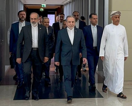 Group of men walking down corridor