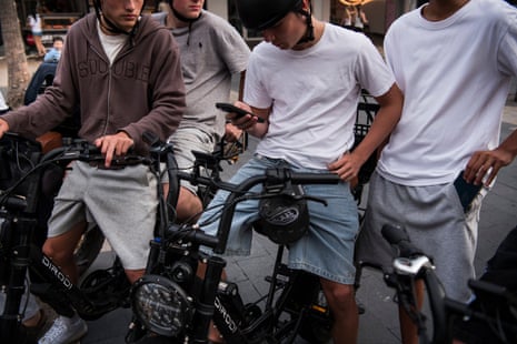 Schoolboys on ebikes at Manly beach on Sydney’s northern beaches