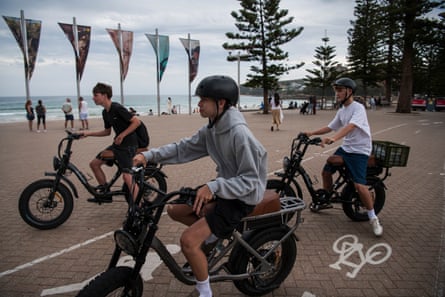 Ben Boucher, 16, and friends on ebikes at Manly beach