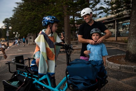 Tyler (who did not provide his last name or wish for it to be published) and his sons Ellis (8) and Sage (5) on their way home on an E-bike after school at Manly Cove.