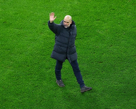 Manchester City manager Pep Guardiola waves to fans at the Etihad Stadium.