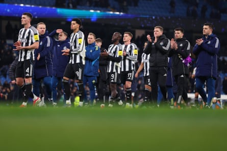 Eddie Howe and his Newcastle players applaud the away fans after the Carabao Cup defeat at Manchester City.