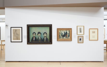 A selection of Lowry’s paintings and drawings hanging on a white wall of the Lowry centre