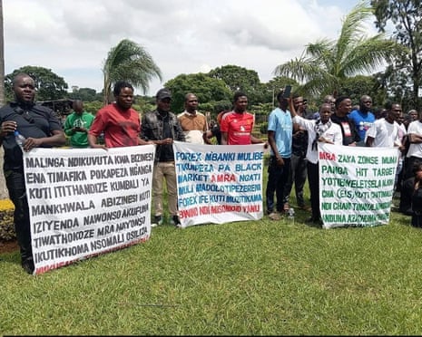 A group of men hold banners