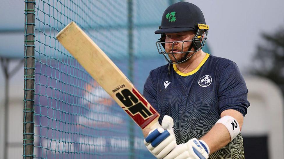 Paul Stirling brandishes his bat during a nets session