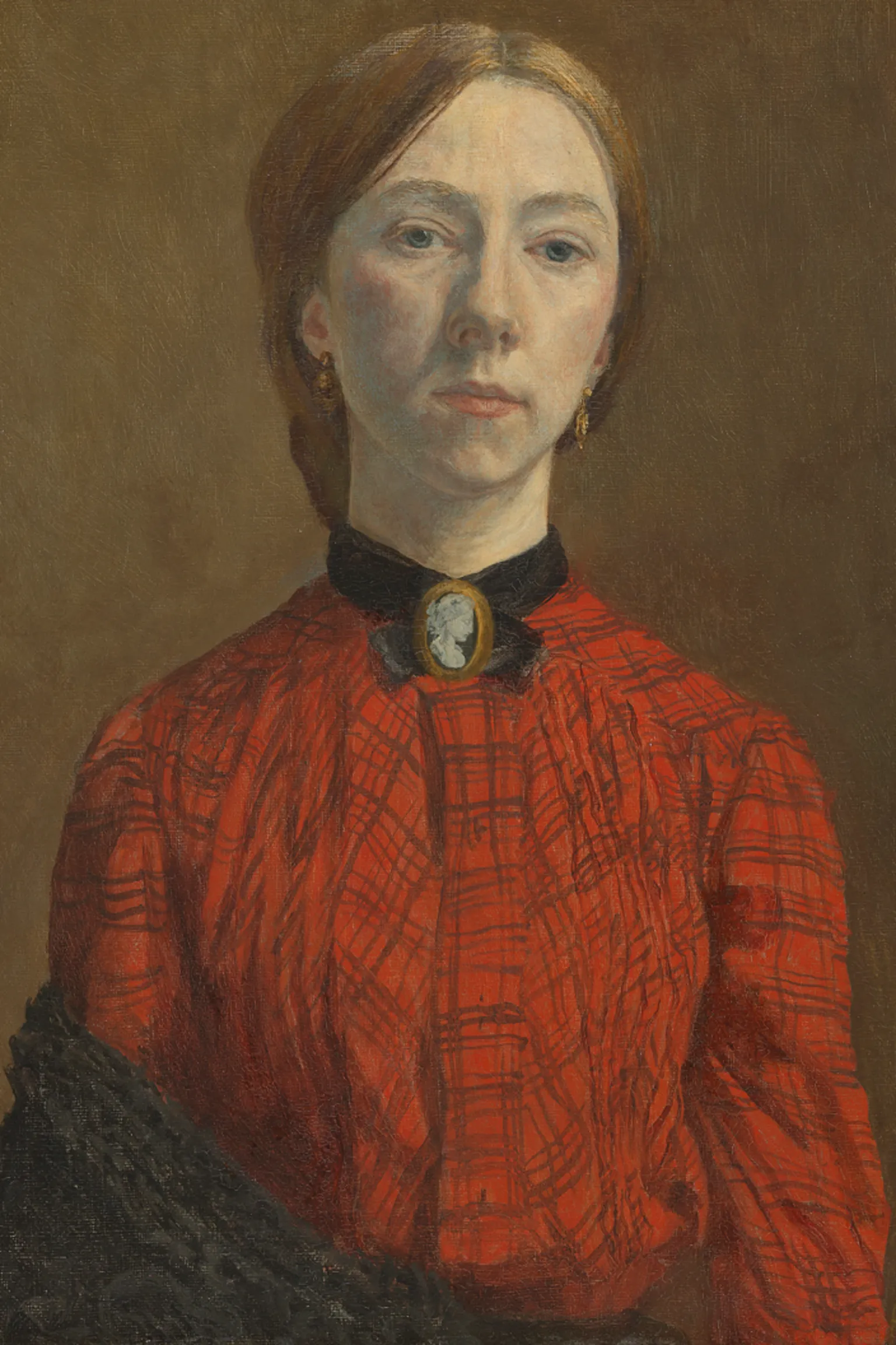 Tate Oil painting of Gwen John. She is a white woman in her twenties. She has light red-brown hair pulled back into a low knot or bun at the back of her head. She is wearing an orange-red blouse with a check pattern on it. at her throat she is wearing a cameo broach with a black ribbon or collar around her throat. The clothing is consistent with the early 1900s. A black shawl is draped over her lower right arm.