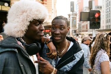 two men stop at a street corner