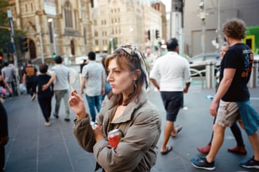 a woman is seen smoking on the street
