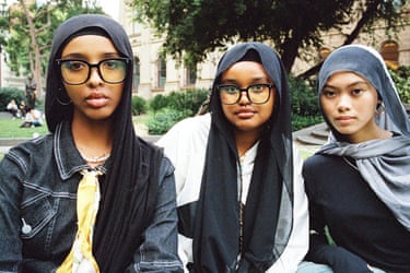 three young women look to camera 
