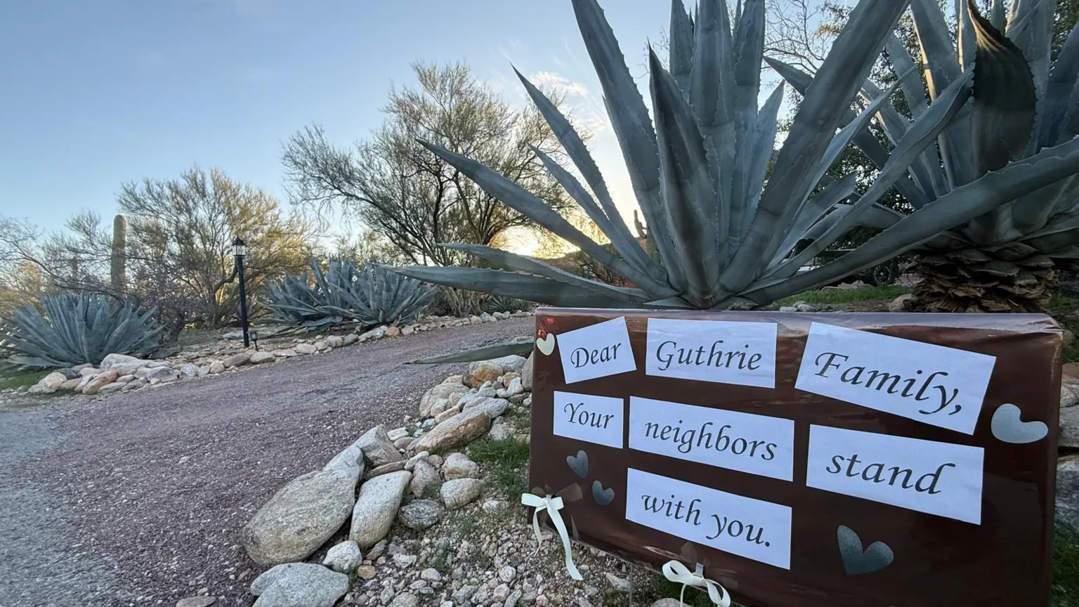 A signs stuck in front of a plant say 