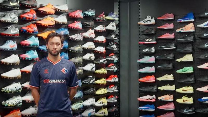 David Choiniere poses in Supra du Quebec's new home shirt inside a football store