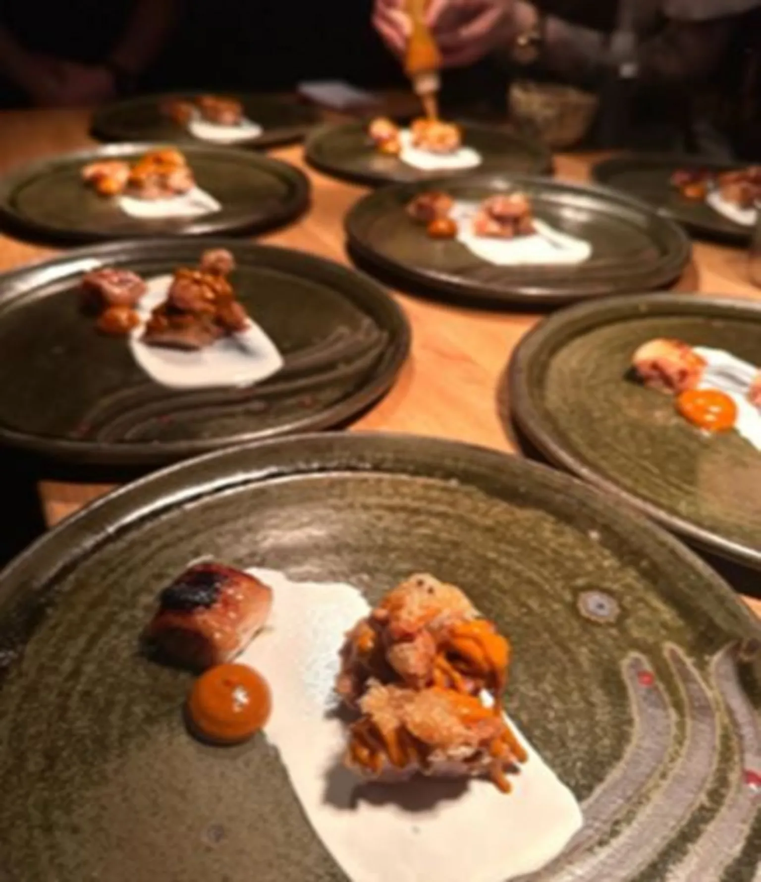 Instagram/Gwen restaurant Plates of food being served - the plate is green and it has a white sauce on it alongside three other bits of food.