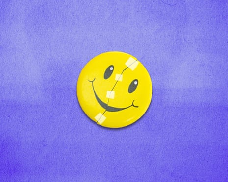 A smiley face on a badge with sticky tape