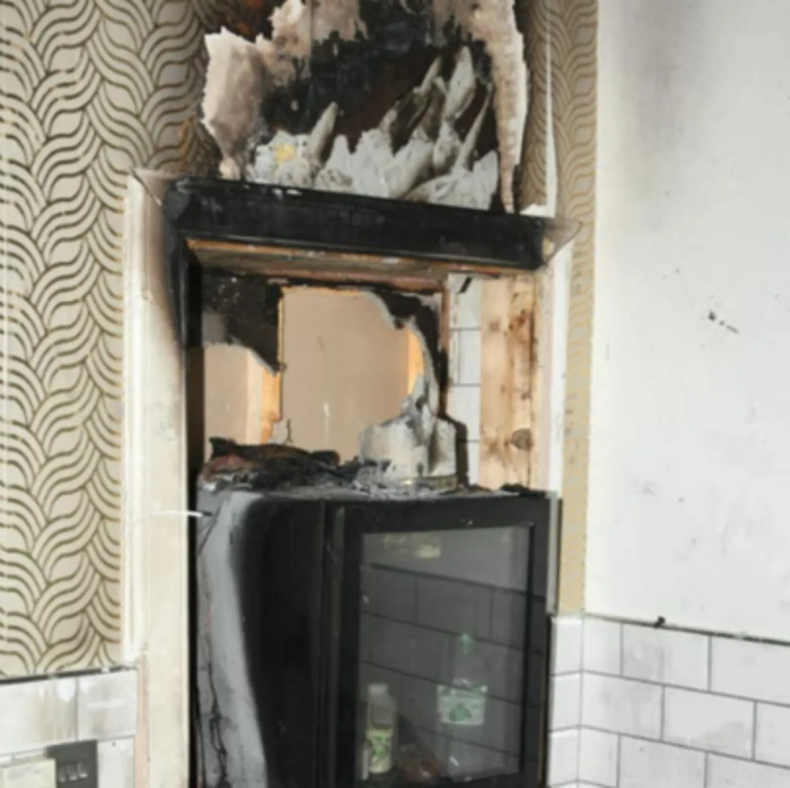 Crown Office Fire-scorched wallpaper surrounds a fire-damaged TV set