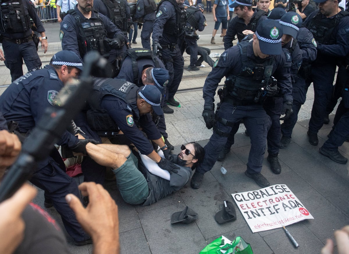 Police arresting a demonstrator at Sydney’s Town Hall last night.