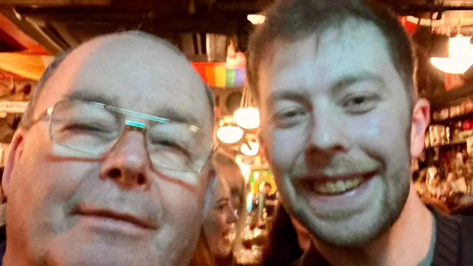 Dougie Breslin Two men appear close to camera in a selfie shot. The man on the leftis bald and wear glasses, while the man on the right has short brown hair and is smiling. They are standing in a pub.