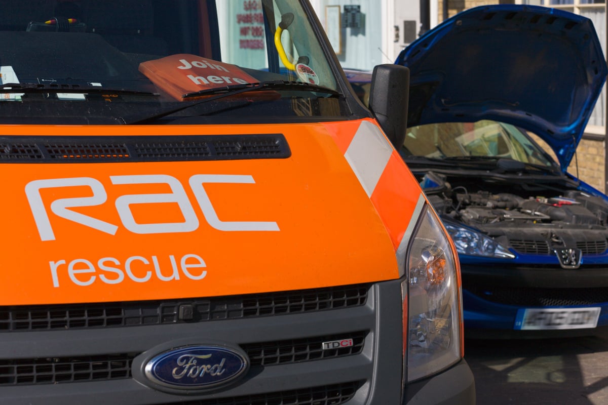 An RAC van rescues a broken down car outside a row of terrace houses