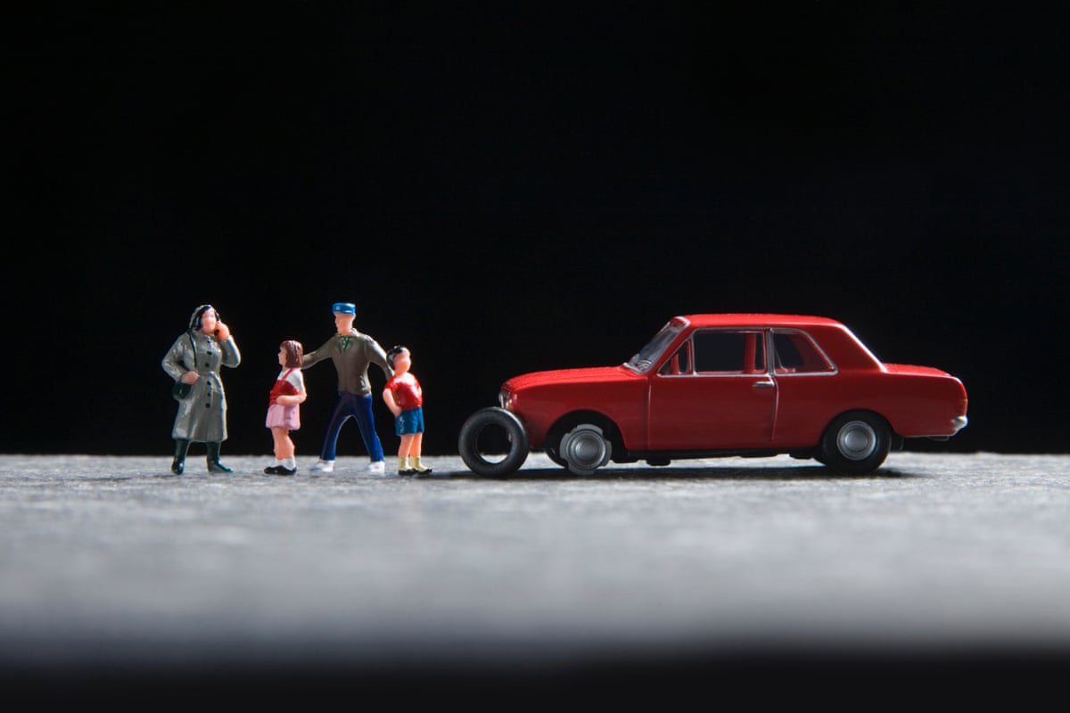 An illustration using figurines depicts a family with a broken down car