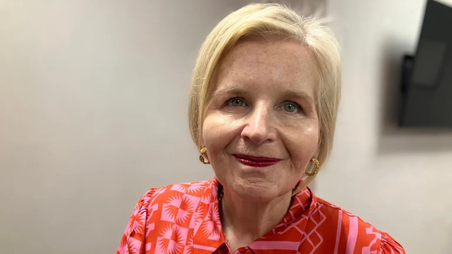 Image of Donna Ockenden. She has blonde hair and is wearing pink/red dress.