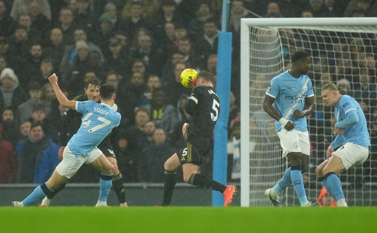 Manchester City's Phil Foden (left) sees his shot at goal headed clear by Fulham's Joachim Andersen.