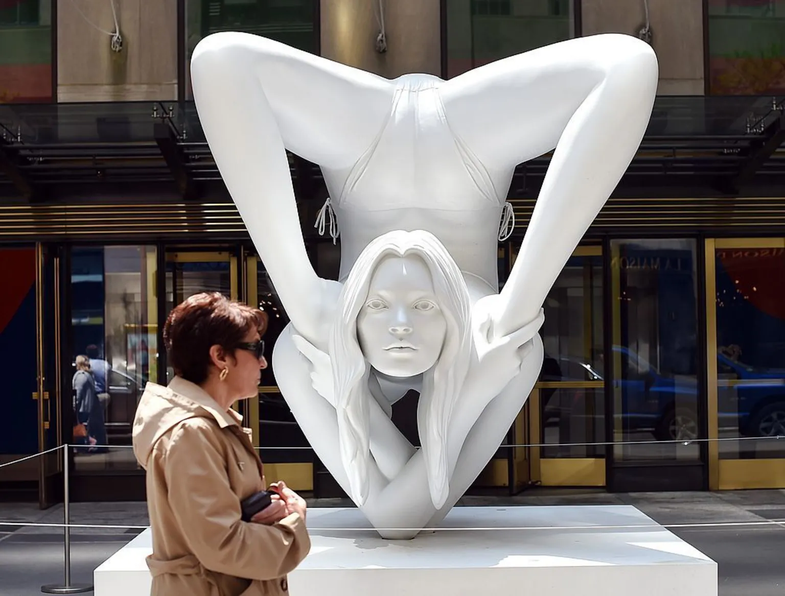 AFP via A woman passes by a sculpture by Marc Quinn titled 