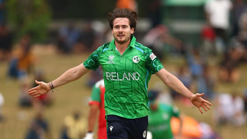 Josh Little spreads his arms in celebration