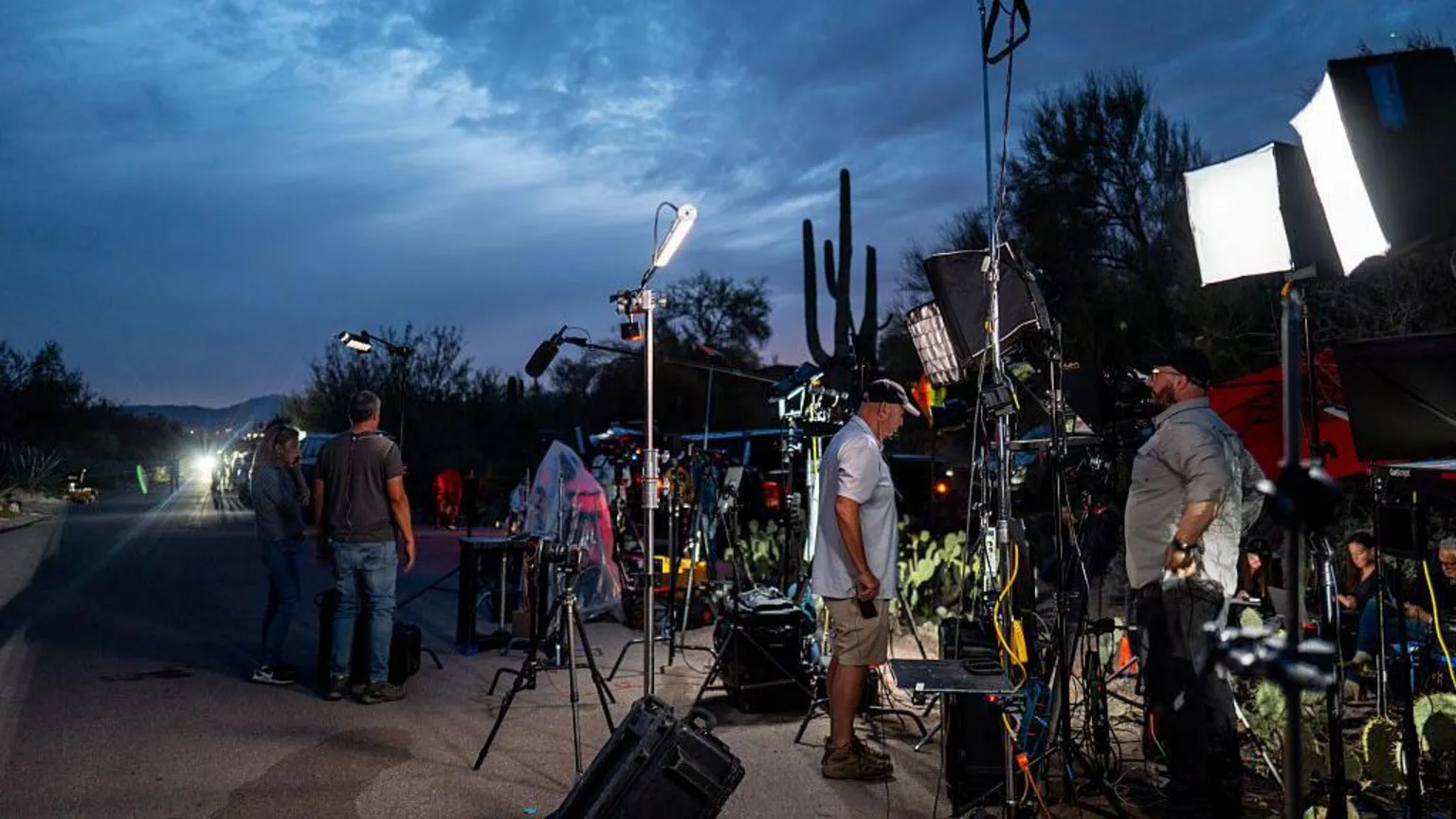  Camera crews setup near Nancy Guthrie's home, the sky is dark, with with the sun nearly set