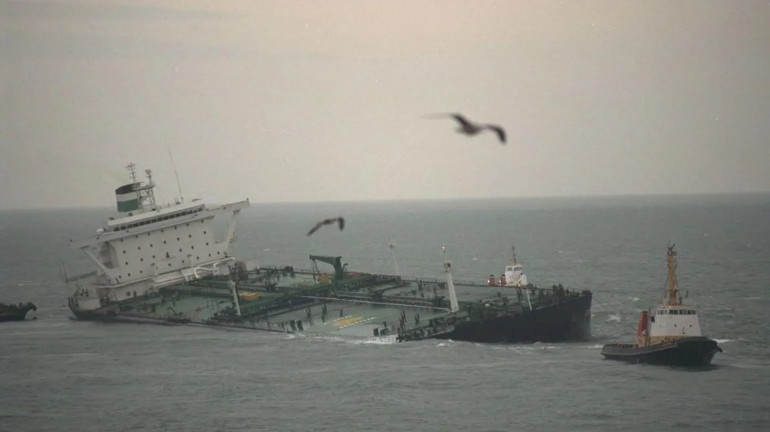  The Sea Empress pictured listing to side, with tug boats on either side