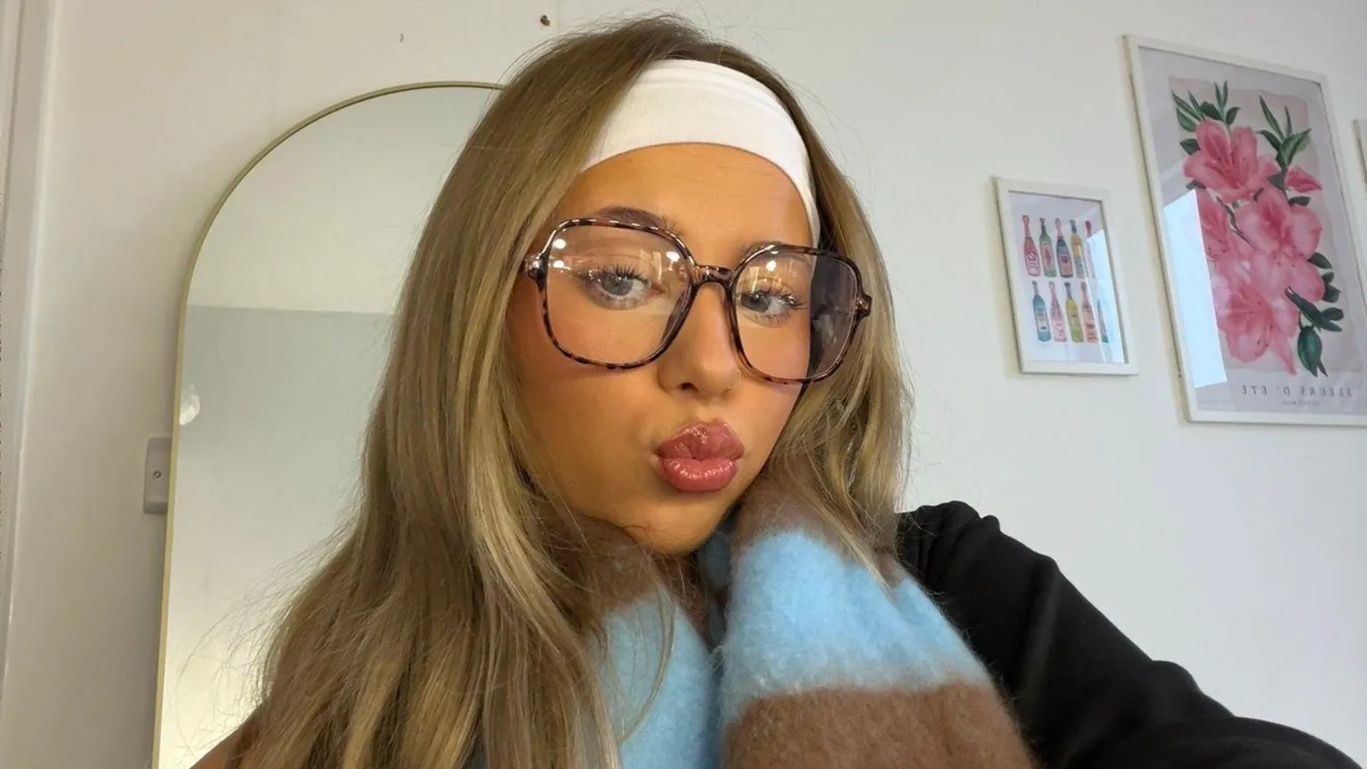 Chloe Harmer Chloe with long straight blonde hair pouting as she takes a selfie with her mirror behind her