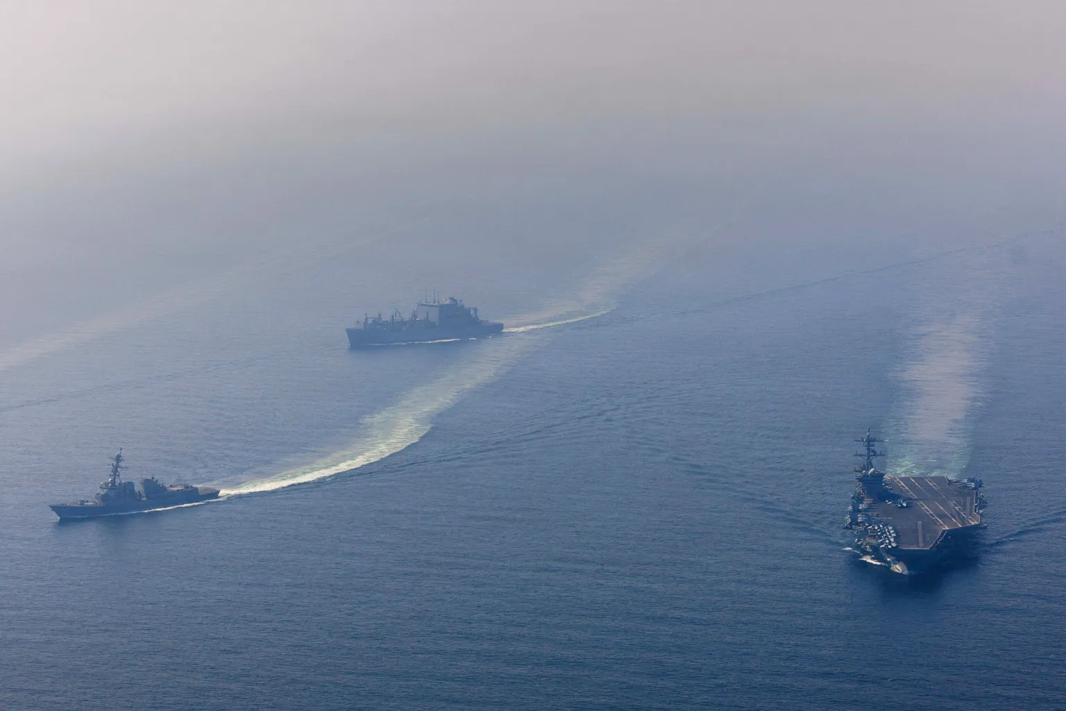  The U.S. Navy's Nimitz-class aircraft carrier USS Abraham Lincoln, Arleigh Burke-class guided-missile destroyer USS Frank E. Petersen Jr. and Lewis and Clark-class dry cargo ship USNS Carl Brashear sail during a photo exercise in the Arabian Sea, February 6, 2026. 