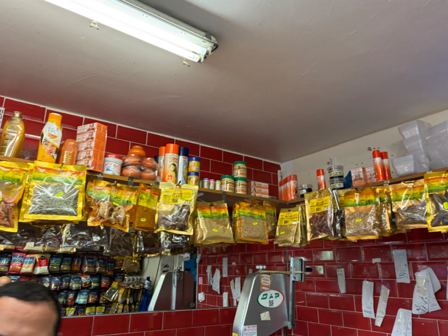 Southwark Trading Standards Inside a butcher's shop in Southwark, London packets of spices hang from a shlef on top of which are bottles and containers of illegal skin whitening products