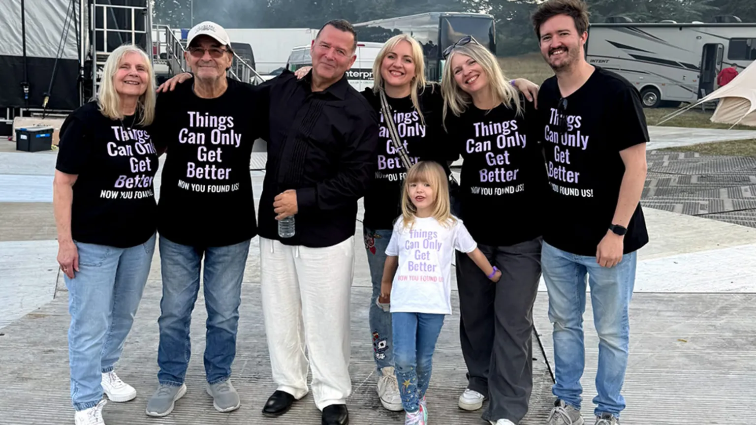 Family handout Shows seven people - three women and two men are wearing T-shirts saying Things Can Only Get Better now you found us. Third from left, Peter Cunnah is wearing a black shirt and white trousers and next to him a young girl with blond hair is wearing jeans and a white T-shirt with the same slogan. 