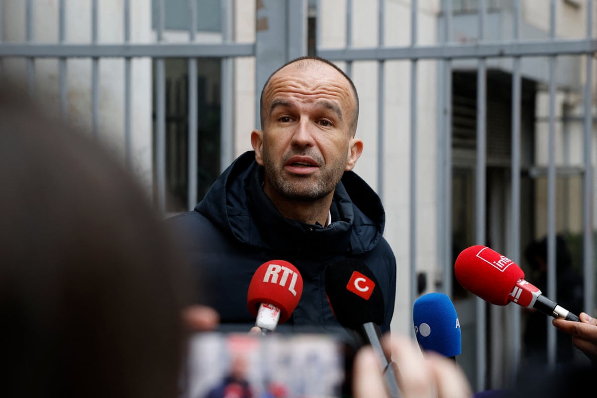 Manuel Bompard talks to the press outside the party's headquarters after its evacuation.
