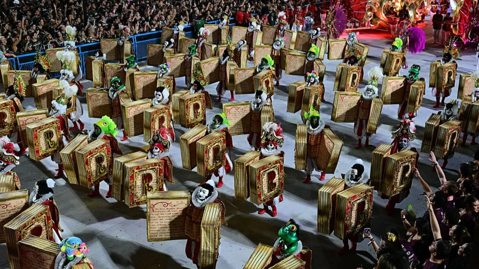  Revellers of the Academicos do Salgueiro samba school perform as dancing books.