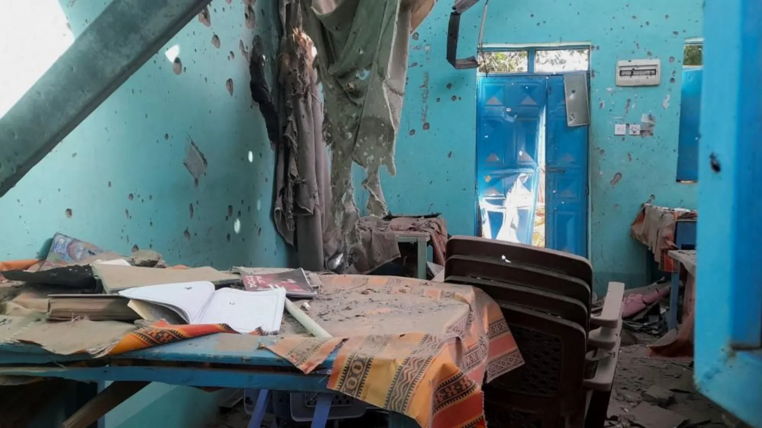  A desk bearing signs of shelling in a school where displaced people are sheltering, in El Fasher