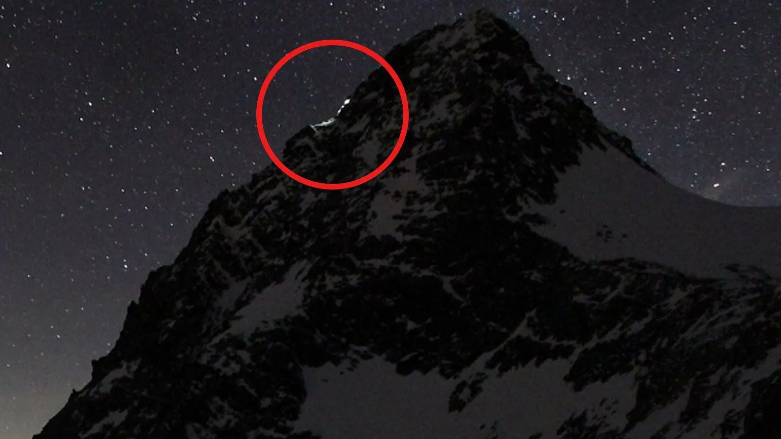 www.foto-webcam.eu A red circle shows a torchlit climb on a mountainside in Austria