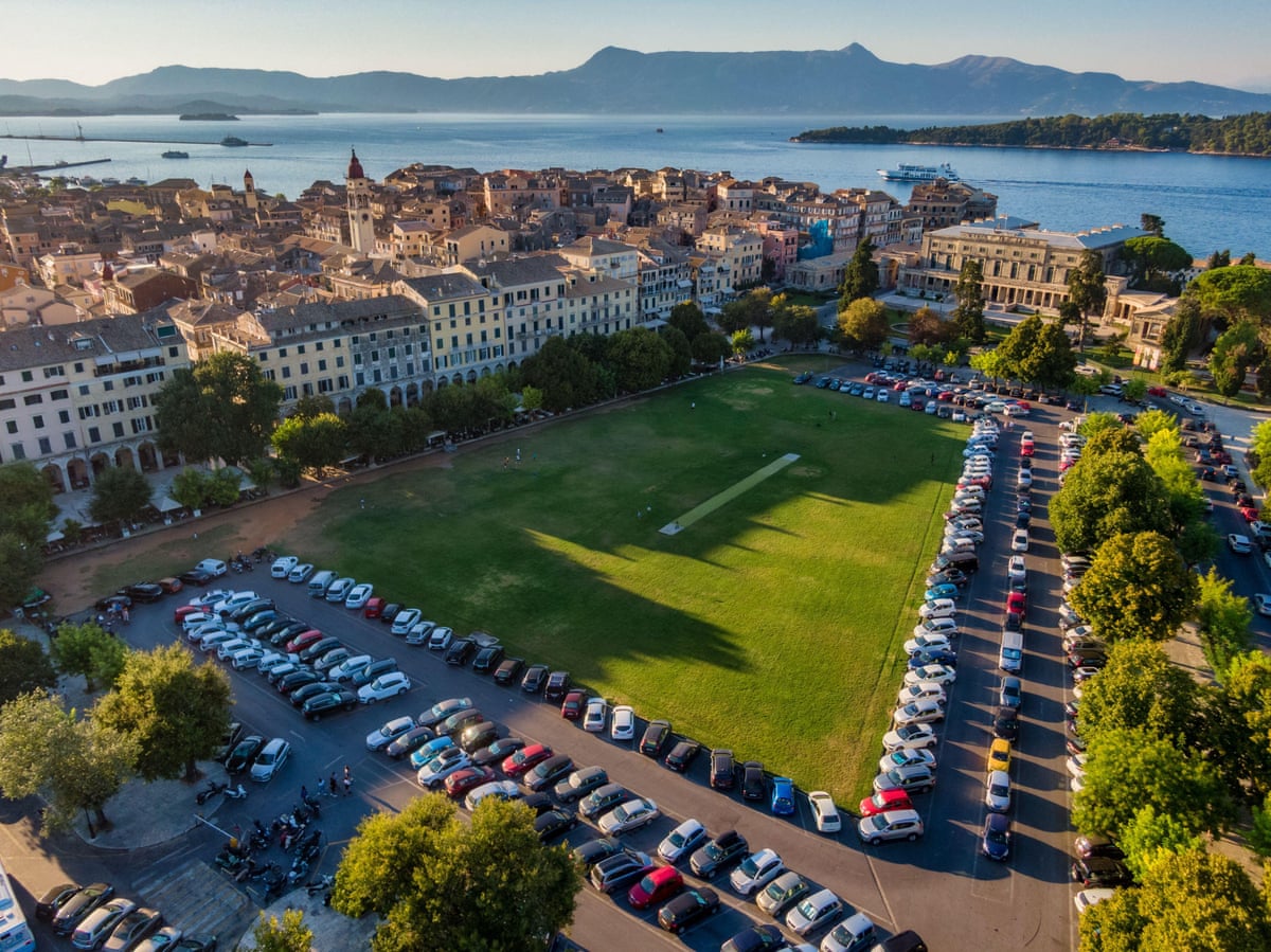 Cricket pitch in old town with sea beyond