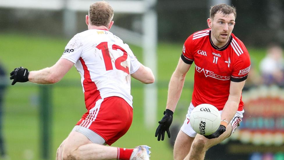 Sam Mulroy gets past Tyrone's Frank Burns 