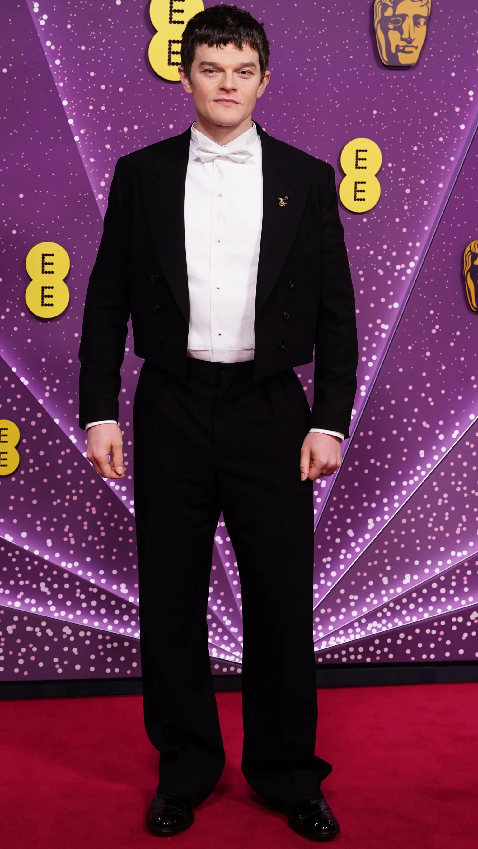  Robert Aramayo in a black suit and white shirt