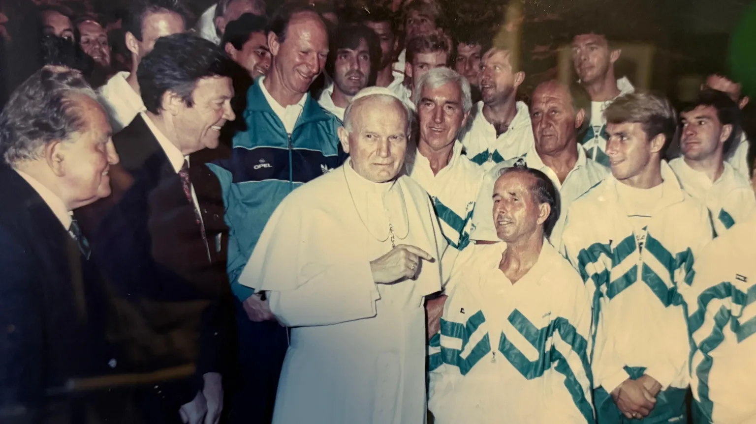 O'Leary family A group of people - Republic of Ireland players and backroom staff - meeting Pope John Paul II. The players and staff are in white and green tracksuits while manager Jack Charlton stands behind the pope in a green tracksuit top. The pope is in the centre of the image in a white cassock, beside him is Charlie.